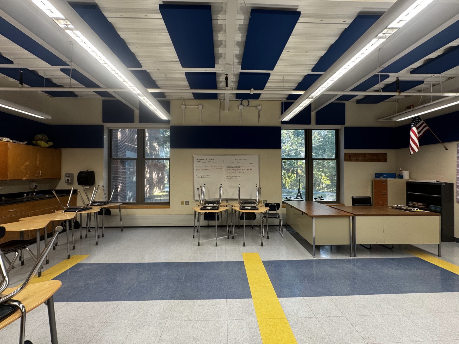 Bromfield classroom after treatment, with navy fabric-wrapped panels on the ceiling and walls