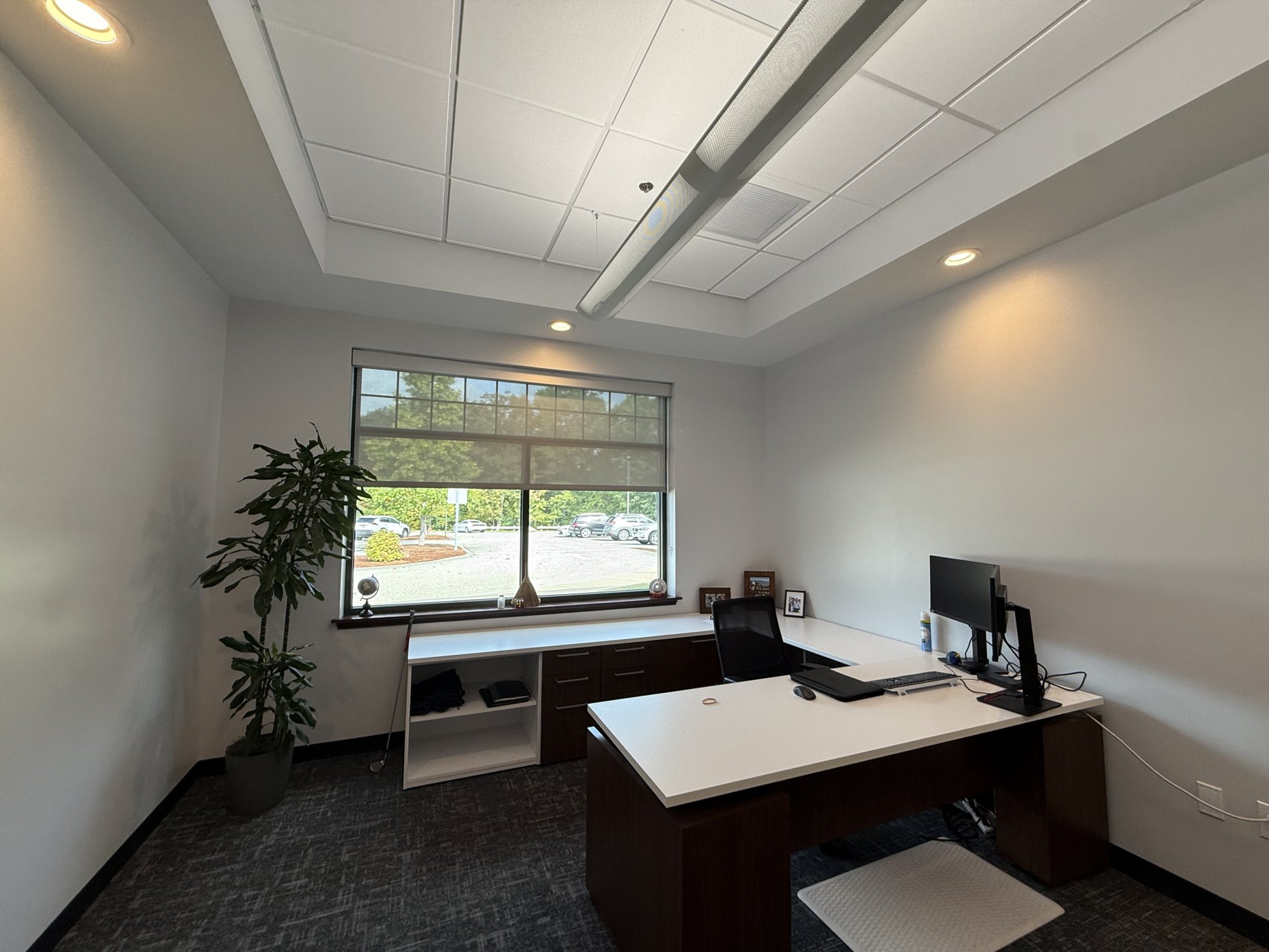 Lenze America executive office before acoustic treatment, with a wall of glass and bare painted drywall